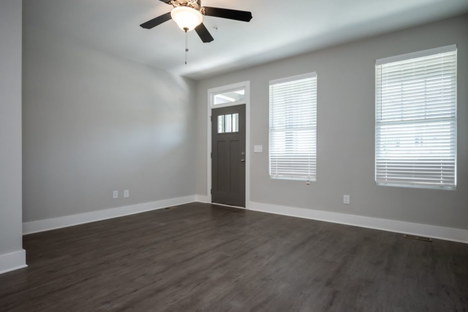 Spacious living room in Puritan Mill townhome featuring hardwood-style floors and contemporary design in Athens, GA.
