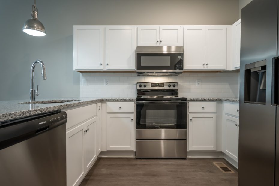 Modern kitchen in Puritan Mill townhome equipped with stainless steel appliances and granite countertops in Athens, GA.