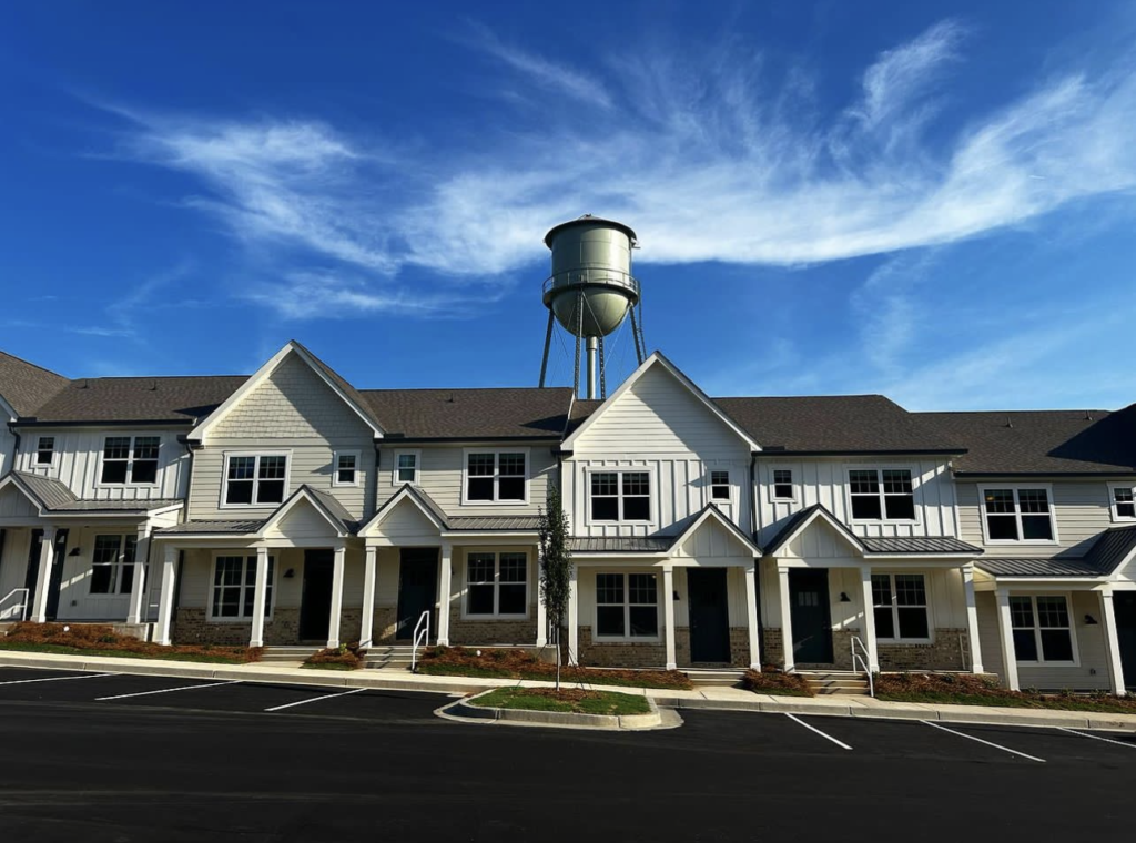 Exterior view of Puritan Mill luxury townhomes in Athens, GA, showcasing modern architecture and landscaping.